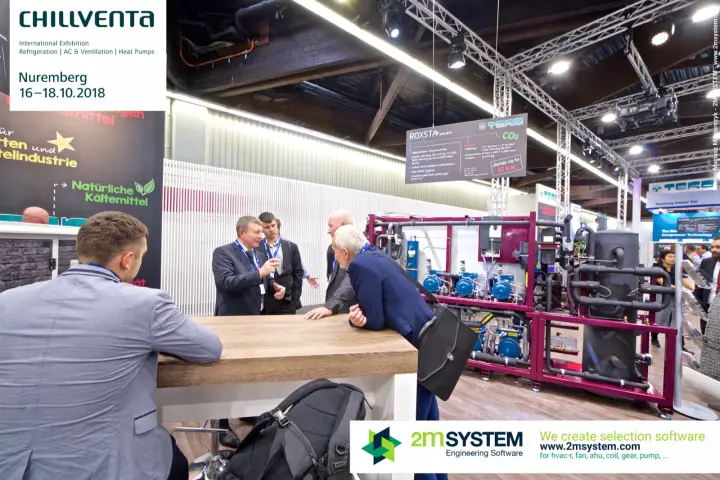 Discussion at a wooden counter beside the TEKO ROXSTAR smart rack at Chillventa 2018
