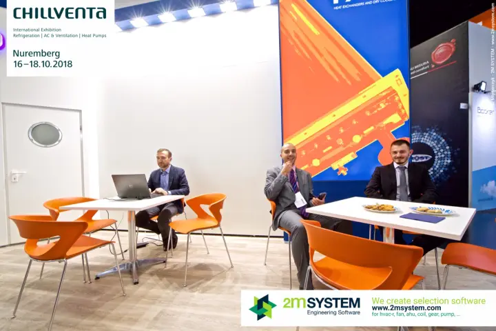 Faco team seated at meeting tables under the heat exchanger graphic at Chillventa 2018