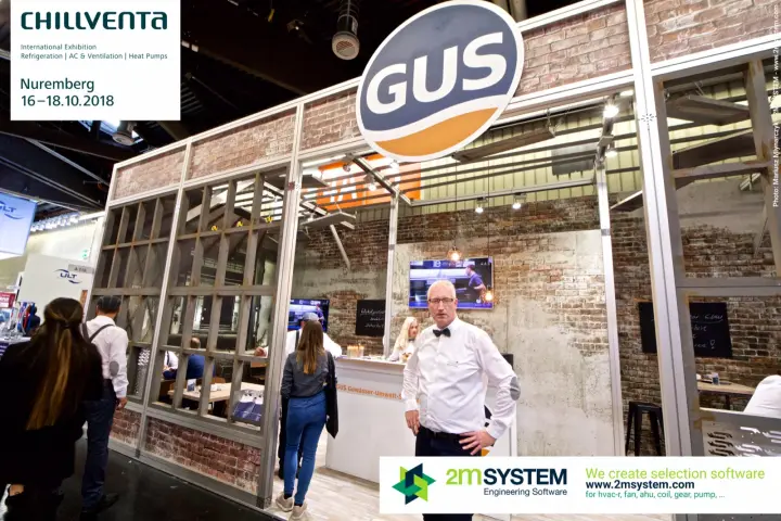 GUS stand styled as a brick-walled workshop with a bar counter