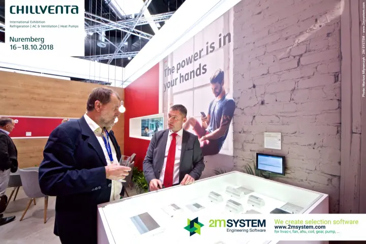 Hitachi control modules in a lit display case below a brick-effect wall at Chillventa 2018