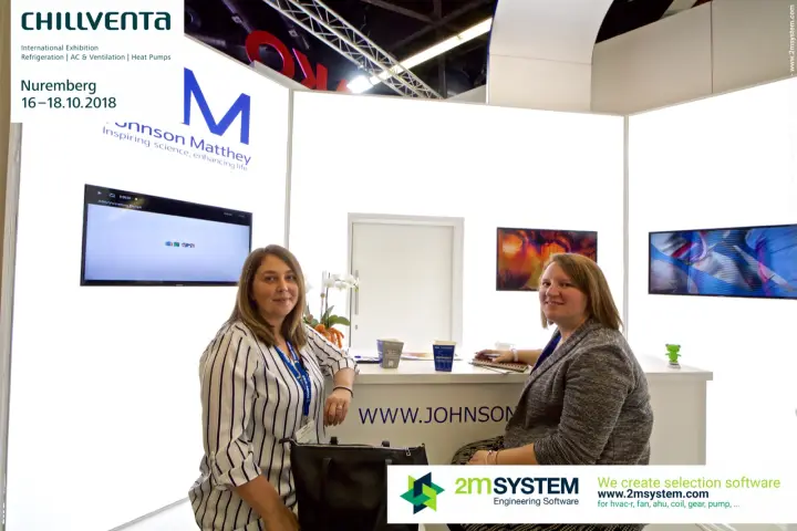Johnson Matthey staff at the counter beneath the blue JM logo