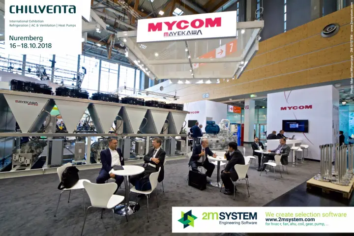 Meeting tables under the MYCOM Mayekawa sign
