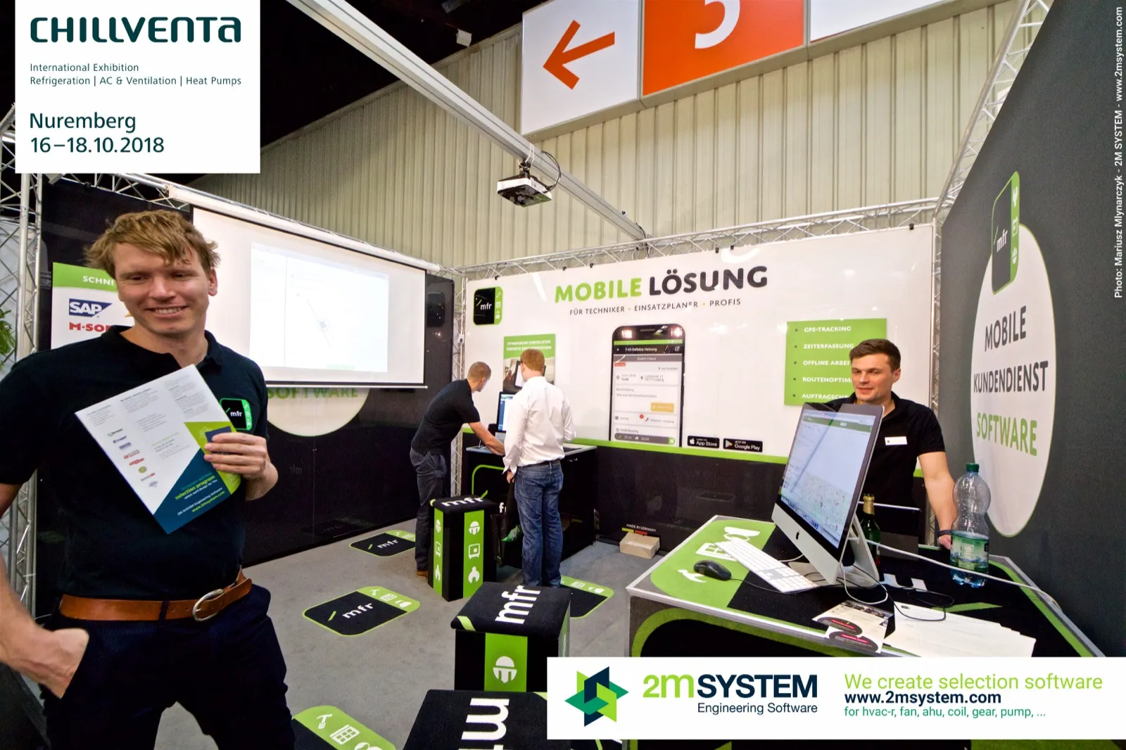 mfr team member holding a brochure in front of the mobile service software stand at Chillventa 2018