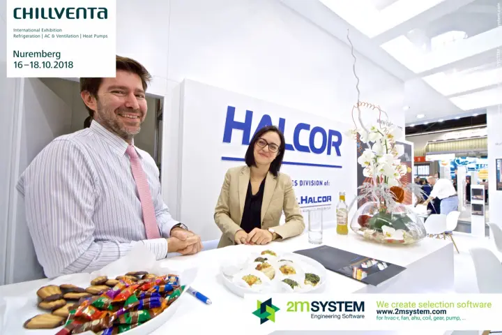 Smiling Halcor representatives at the stand counter with catalogue at Chillventa 2018