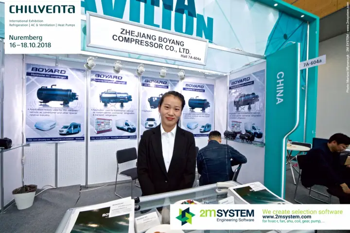 Staff at the Boyard counter in front of compressor application posters