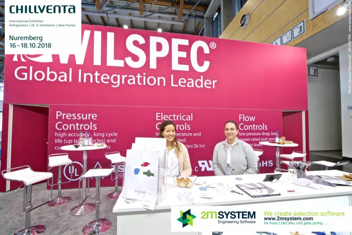 Staff at the Wilspec counter in front of the pressure and flow controls wall