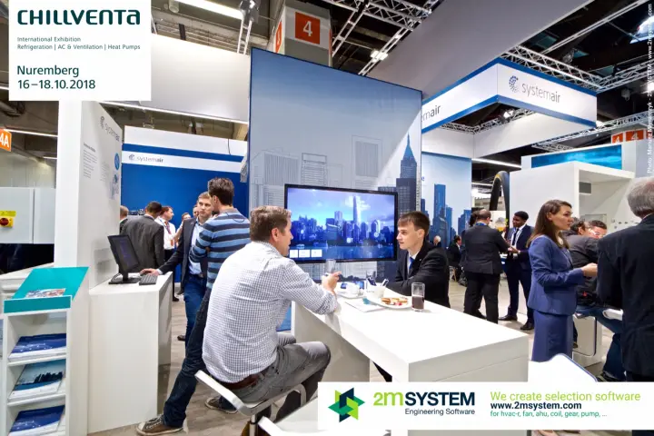 Talks at a white Systemair table beside the skyline screen