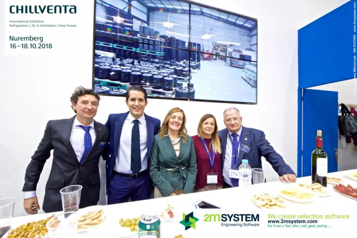 Tecnac staff group photo with warehouse video behind