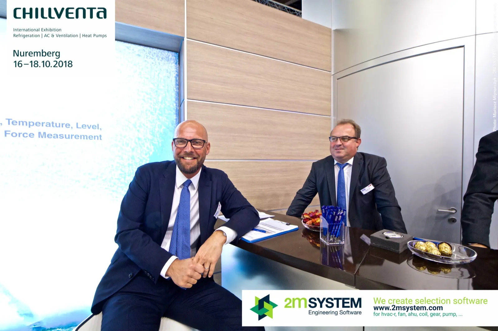 Two WIKA staff members seated at the stand counter at Chillventa 2018