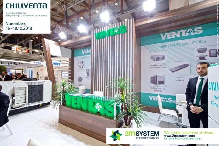 Ventas staff beside the green-lettered counter and product posters