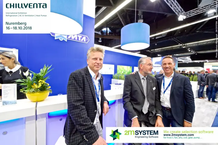 Visitors pose at the MTA bar under the blue drum lamps at Chillventa 2018