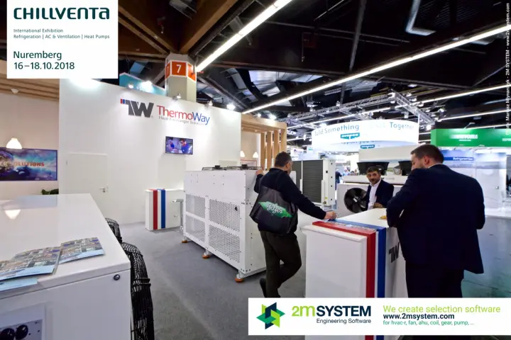 Visitors talking at the ThermoWay counter beside white heat exchanger units