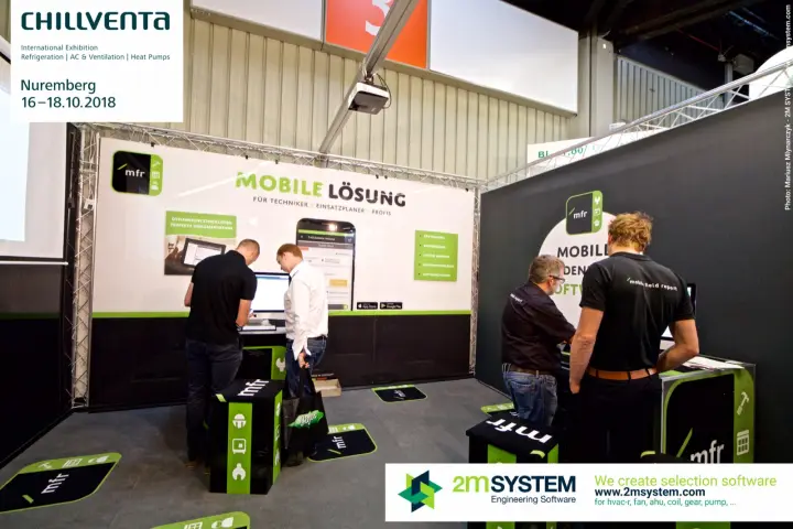 Visitors at two software demo stations on the truss-framed mfr stand