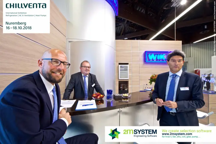 WIKA team at the counter with the blue illuminated logo behind at Chillventa 2018
