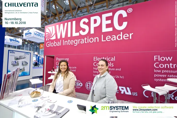 Wilspec team at the counter beneath the magenta brand wall