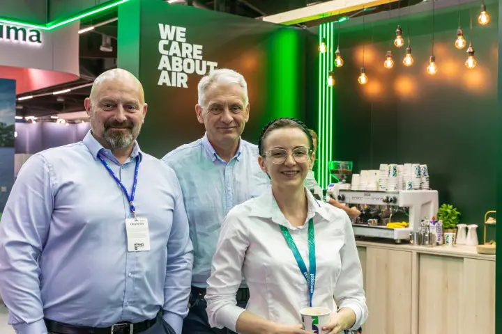 Close portrait of three people under the "We Care About Air" slogan at Chillventa 2026
