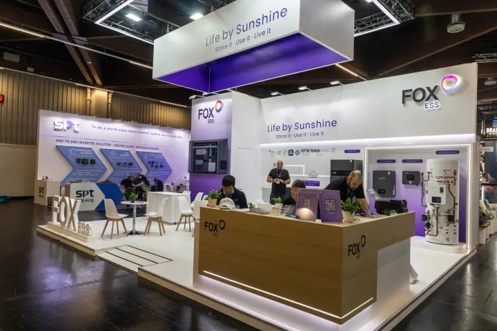 Fox ESS wood-clad reception counter under the purple hanging banner