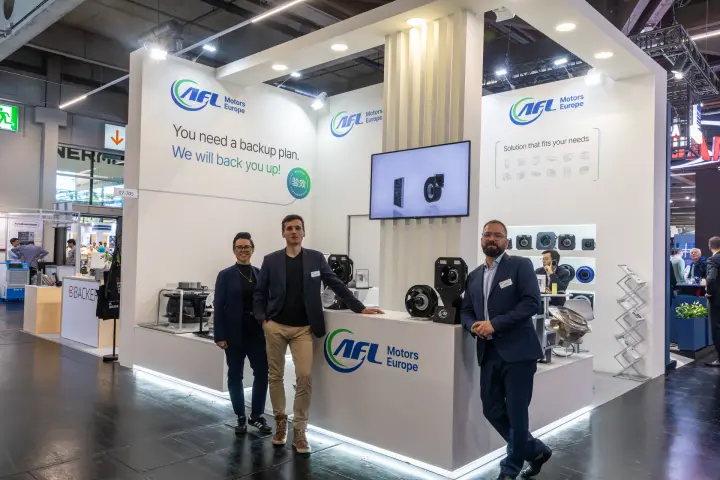 Full view of the white AFL Motors Europe stand with fan displays