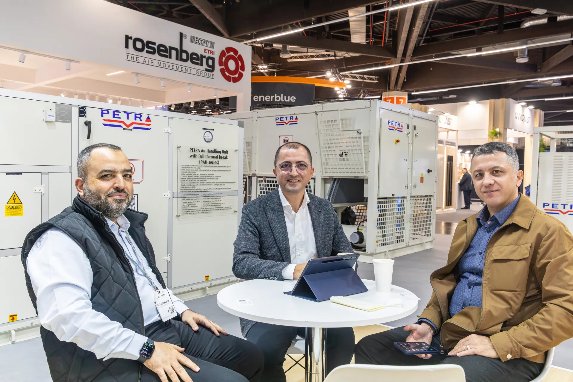 Group at a Petra meeting table with air handling and packaged units behind at Chillventa 2026