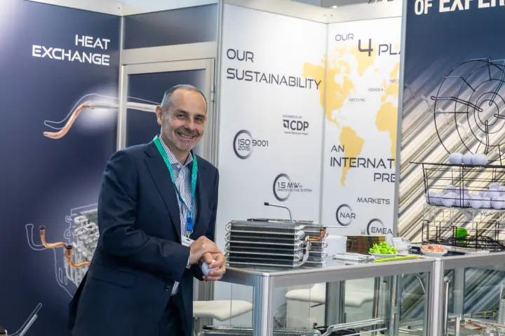 Grupporeco staff member beside finned heat exchanger samples at Chillventa 2026