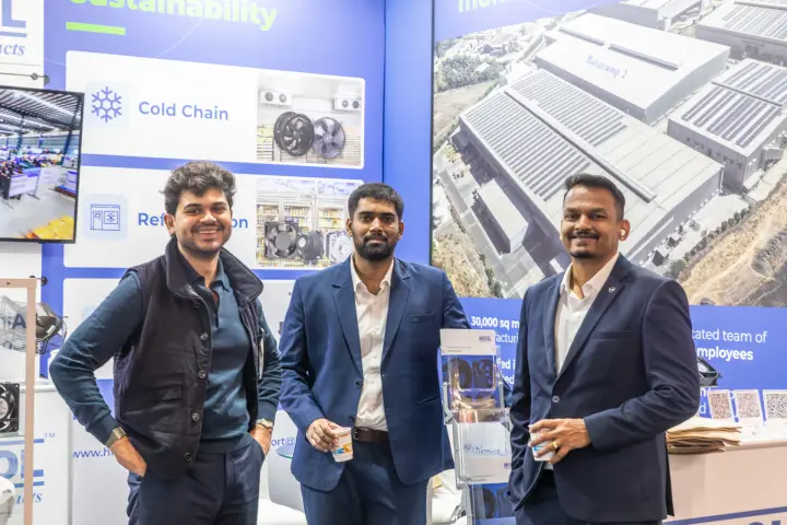 Hicool team in front of cold chain and factory graphics