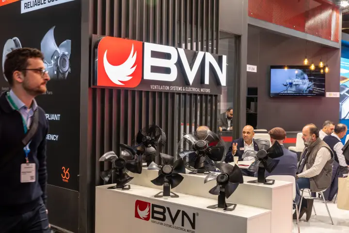 Illuminated BVN sign above a row of black axial fan impellers