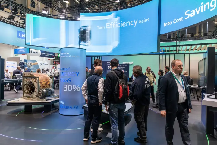 Old belt-driven fan shown as retrofit example under ebm-papst LED wall at Chillventa 2026