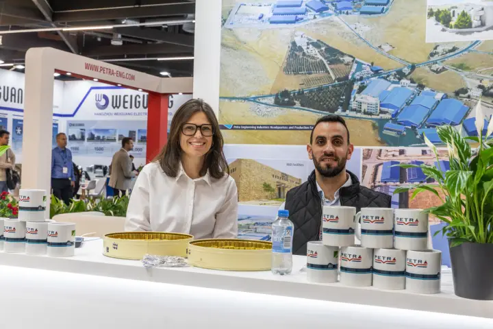 Petra staff portrait with mugs and the Weiguang booth behind at Chillventa 2026