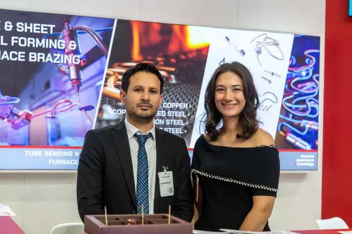 Portrait of the EPTA team at the stand counter with brazing graphics behind at Chillventa 2026