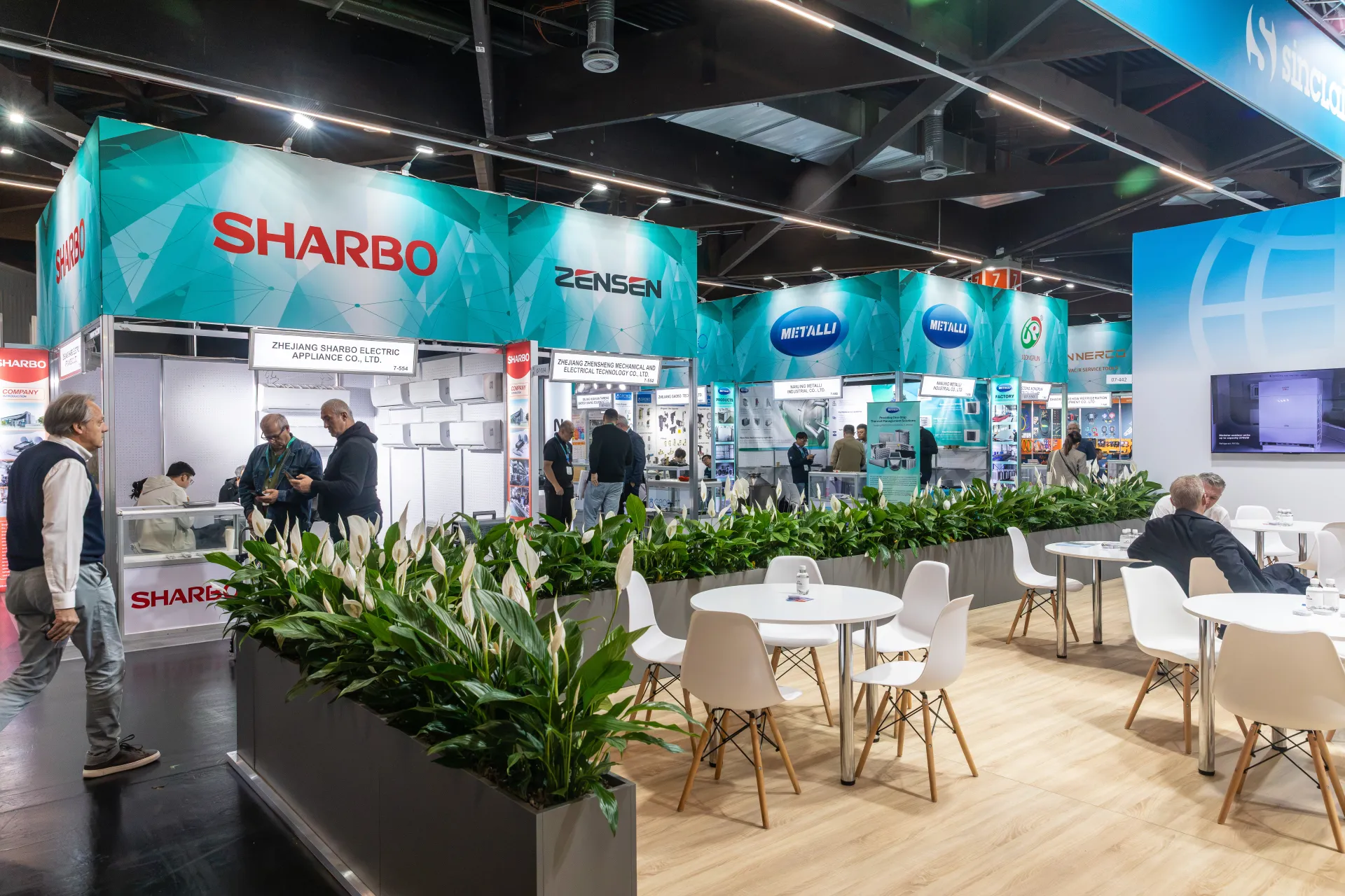 Sharbo and Zensen shell-scheme booths behind a planted lounge area at Chillventa 2026