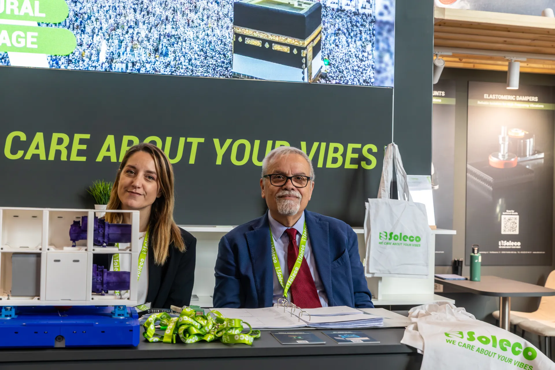 Soleco staff at the counter beneath the "We care about your vibes" slogan at Chillventa 2026