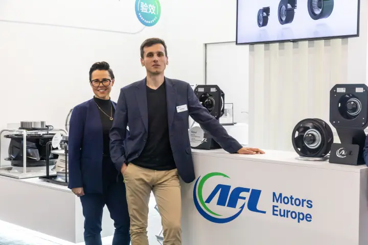 Two AFL Motors Europe team members at the logo counter