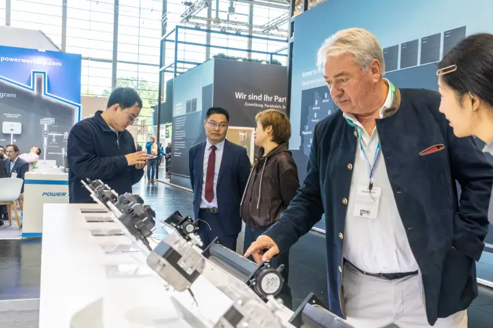 Visitor examining cross-flow fan motors at Power World