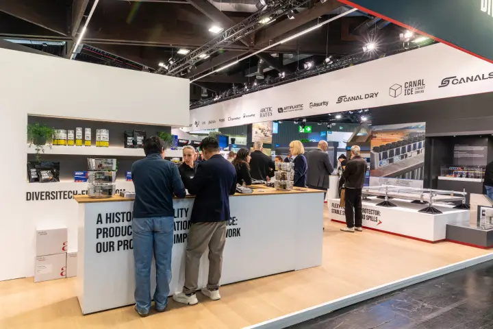Visitors at the DiversiTech counter beneath a frieze of group brand logos at Chillventa 2026
