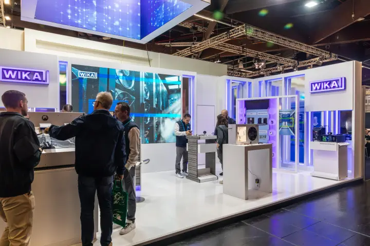 WIKA stand with purple-lit logos, LED wall and calibration technology display at Chillventa 2026