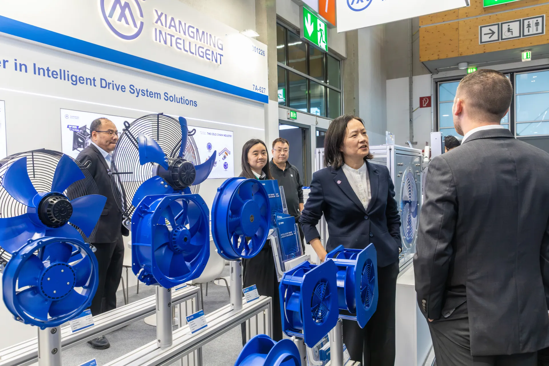 Xiangming Intelligent team presenting a row of blue axial fans at Chillventa 2026