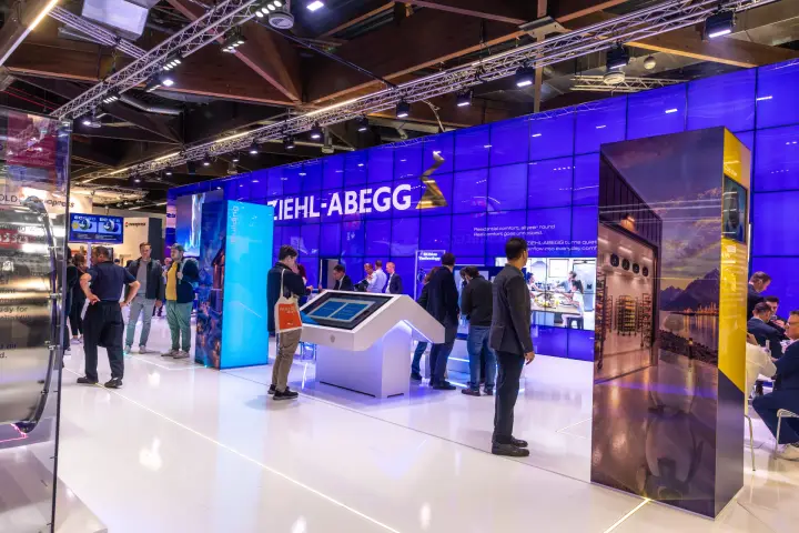 Ziehl-Abegg stand with violet LED wall and touchscreen kiosk