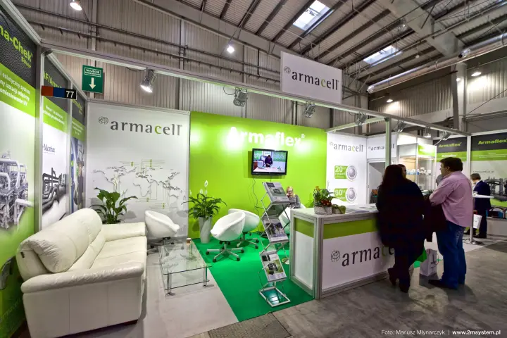 Armacell stand with lime-green Armaflex wall and white lounge seating