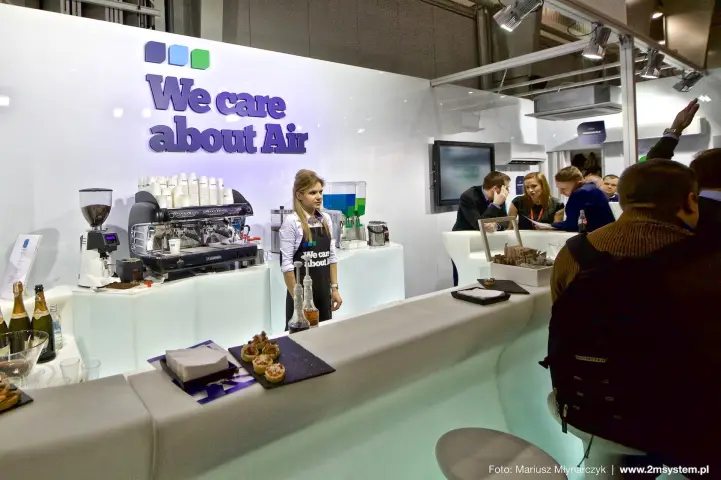 Barista counter with espresso machine and "We care about Air" lettering