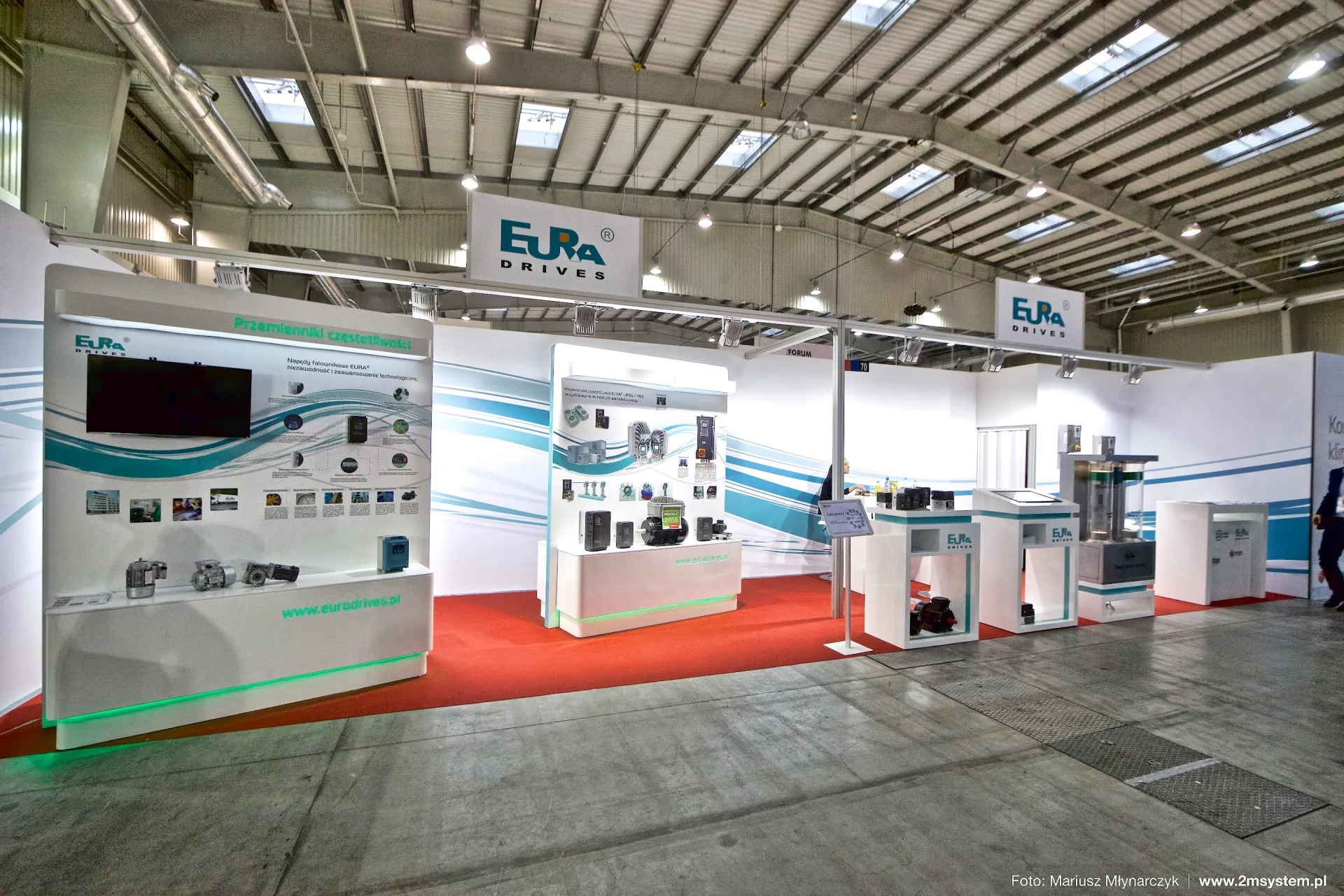 Eura Drives stand with frequency inverter displays and motors on red carpet at Forum Wentylacja 2016