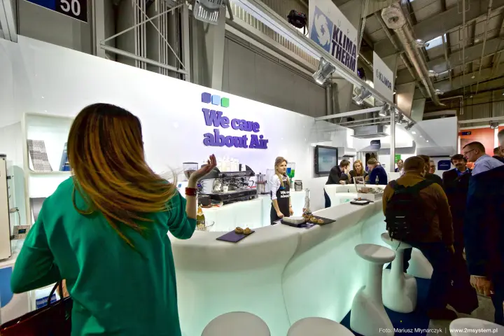 Glowing white coffee bar under "We care about Air" on the Klima-Therm stand at Forum Wentylacja 2016