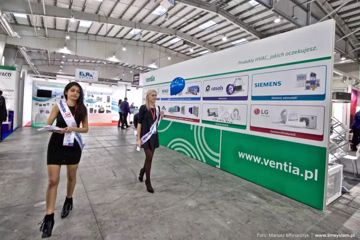 Hostesses walking past the Ventia product wall