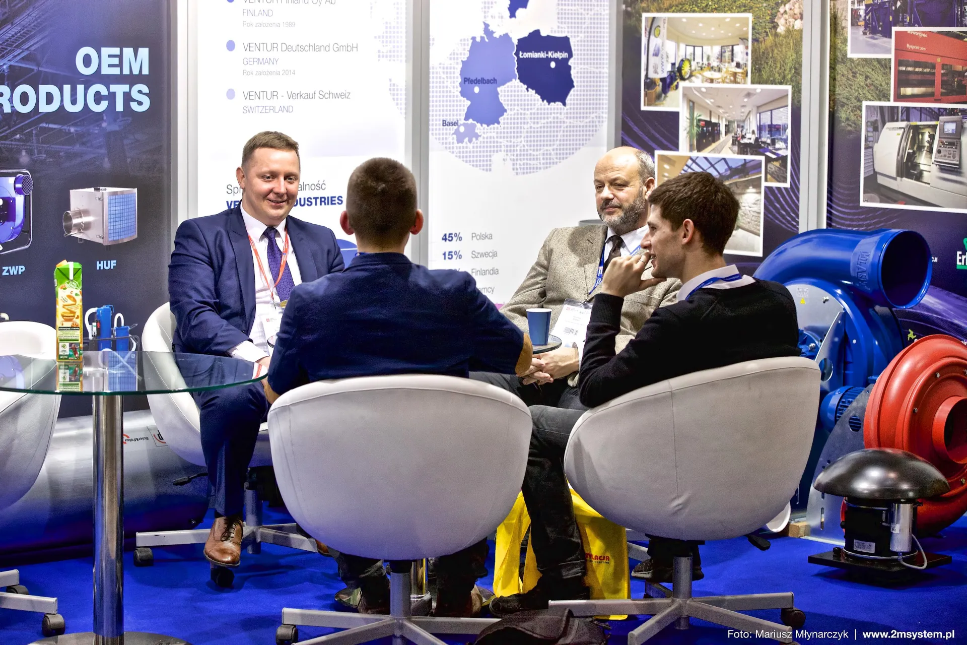 Venture Industries staff in conversation beside centrifugal fan display at Forum Wentylacja 2016