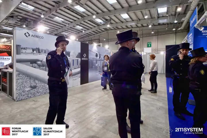 Aisle beside the Aereco back wall with visitors in chimney sweep uniforms at Forum Wentylacja 2017