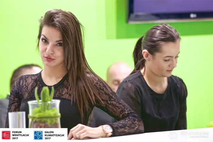 Armacell stand hostesses at the counter, closer framing at Forum Wentylacja 2017