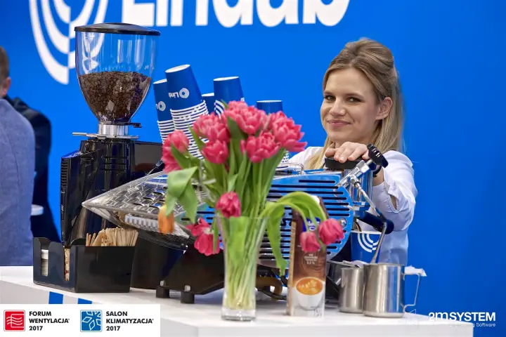 Barista at the Lindab coffee bar with branded blue cups at Forum Wentylacja 2017