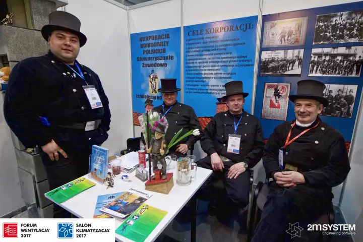 Chimney sweeps in traditional top hats at the Korporacja Kominiarzy Polskich stand