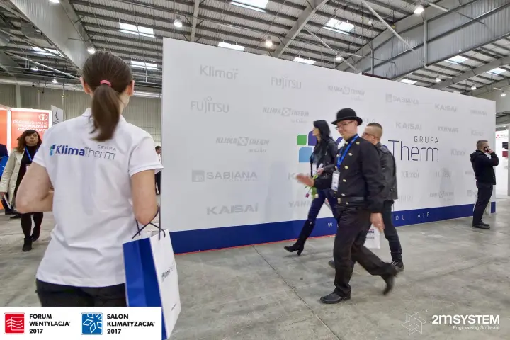 Chimney sweeps walking past the Klima-Therm brand wall at Forum Wentylacja 2017