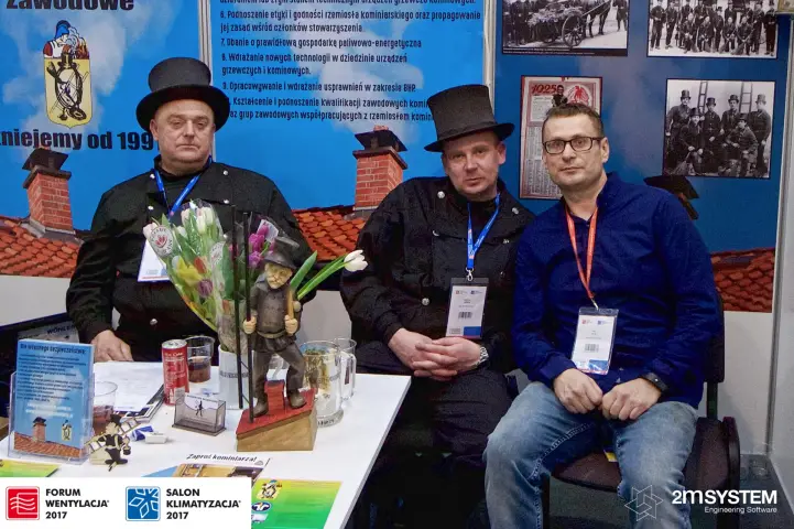 Group portrait at the chimney sweeps' association table with a carved figure