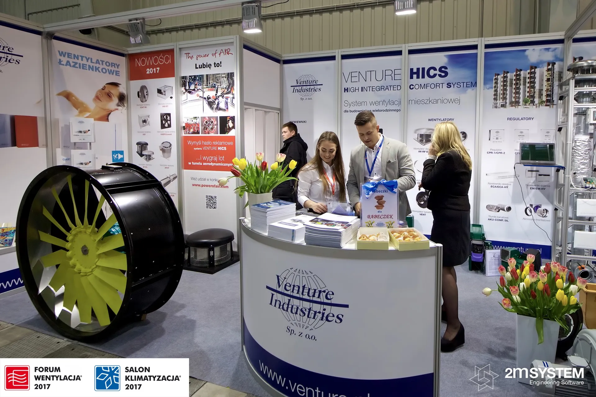 Large axial fan with yellow blades beside the Venture Industries counter at Forum Wentylacja 2017